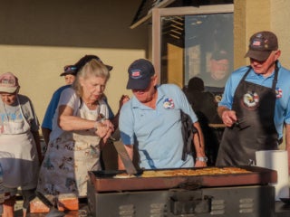 Members of Veterans Club at The Meadows in Tarpon Springs, FL, making food for a club fundraising event.