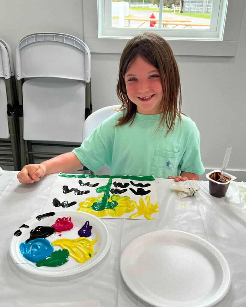 Camper doing a finger painting craft at Creekfire RV Resort in Savannah, Georgia