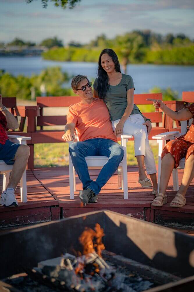 Couple sitting at the fire pit with the Little Manatee River in Ruskin, Florida.