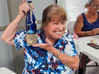 Residents with their decorated blue glass bottle creations from a craft class at Holiday RV Park in Leesburg, FL.
