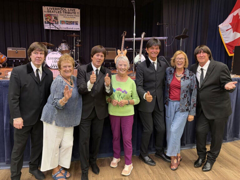 Residents at Jamaica Bay Village in Fort Myers, Florida taking a picture with Liverpool Live a Beatles Tribute band
