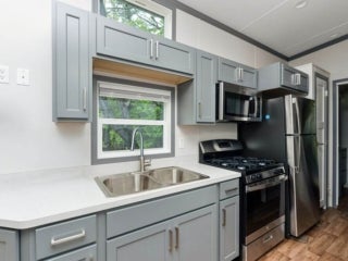 The kitchen inside of a park model cabin at Point Sebago Resort in Casco, Maine.
