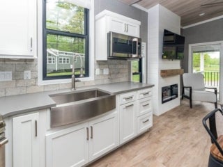Inside the kitchen of a park model cabin at Point Sebago Resort.