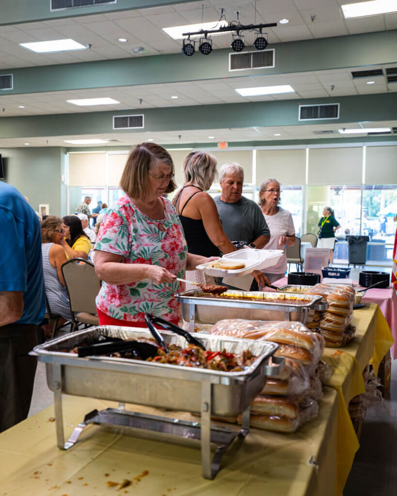 Guests grabbing food at the Resident Picnic in Cypress Lakes Village in Lakeland, Florida.