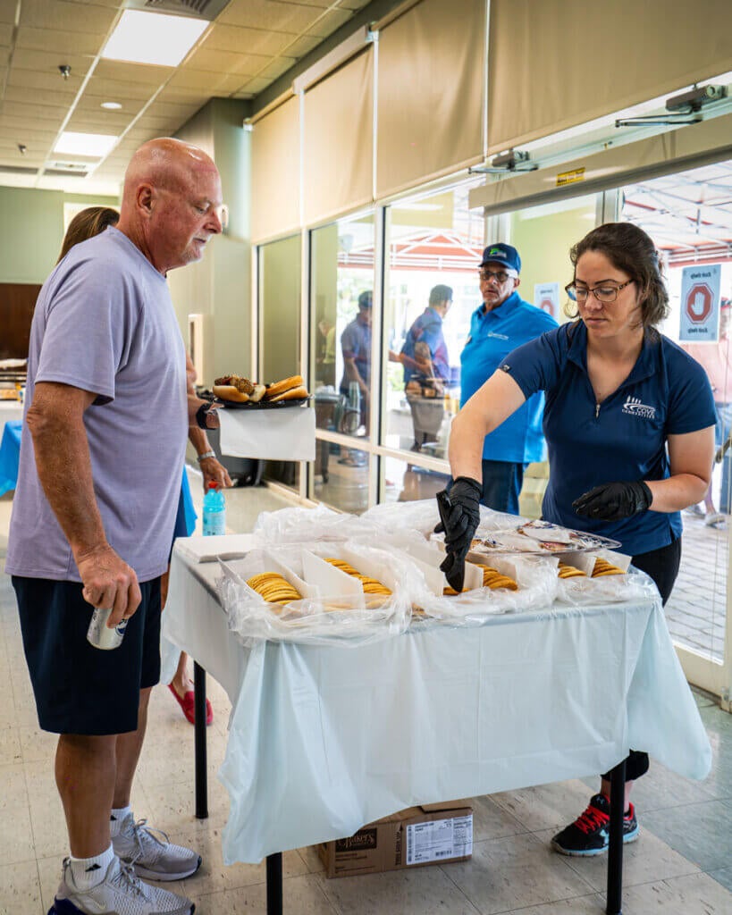 Team members serving food at the Resident Picnic in Cypress Lakes Village in Lakeland, Florida.