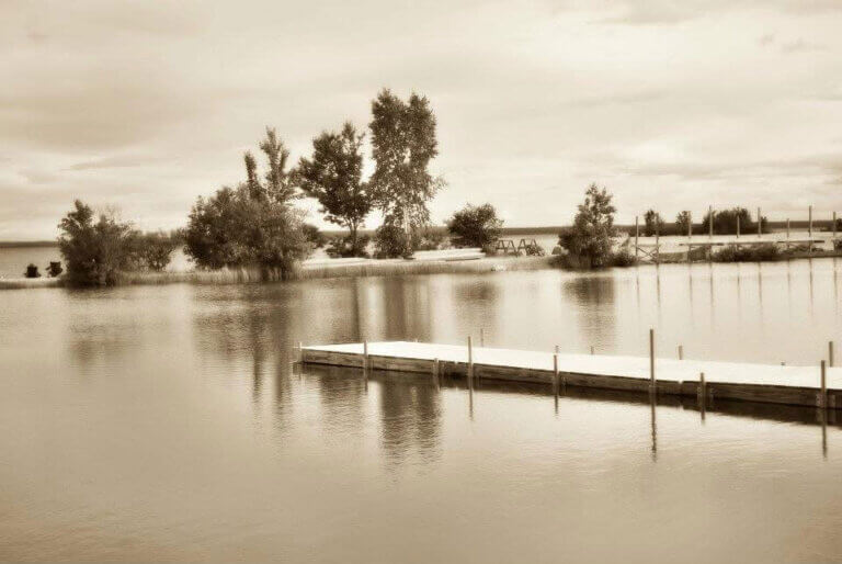 Sepia colored image of a dock at Point Sebago in Maine.