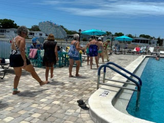 Residents dancing by the pool at the Luau themed party at The Meadows in Tarpon Springs, Florida