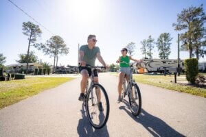 A father and daughter bicycling through River Vista RV Park in Ruskin, Florida.