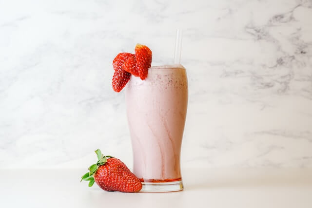 Image of a strawberry milkshake with a marble background