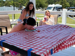 Guests at Creekfire RV Resort in Savannah, Georgia participating in a watermelon eating contest