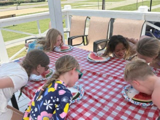 Guests at Creekfire RV Resort in Savannah, Georgia participating in a watermelon eating contest
