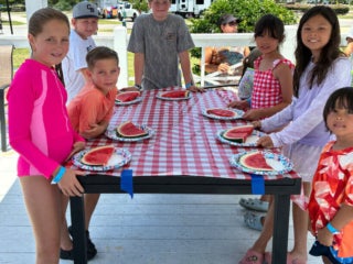 Guests at Creekfire RV Resort in Savannah, Georgia participating in a watermelon eating contest