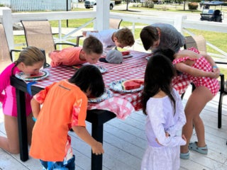 Guests at Creekfire RV Resort in Savannah, Georgia participating in a watermelon eating contest