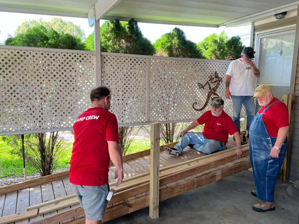 Residents volunteers for AMBUCS at Cypress Lakes Village in Lakeland, Florida building a ramp for residents within the community