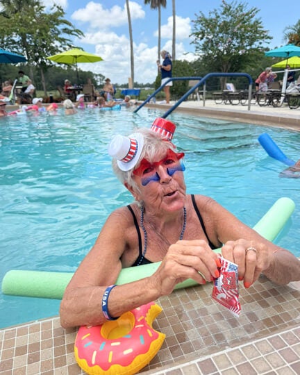 Resident with patriotic glasses on is in the pool during the Independence day celebration at Cypress Lakes Village in Lakeland, FL.