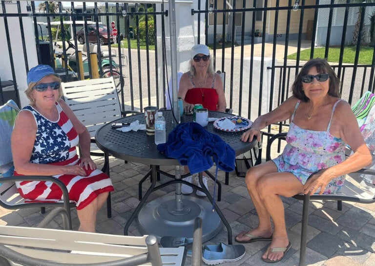 Residents at The Waters in Melbourne Beach, Florida enjoying a community BBQ by the pool