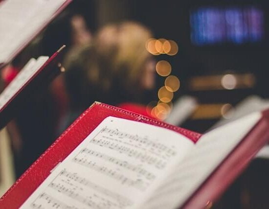 Sheet music in a red binder during Christmas time.