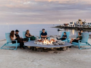 The Hocking family sitting around the oceanside fire pit at Big Pine Key RV Park in Florida.
