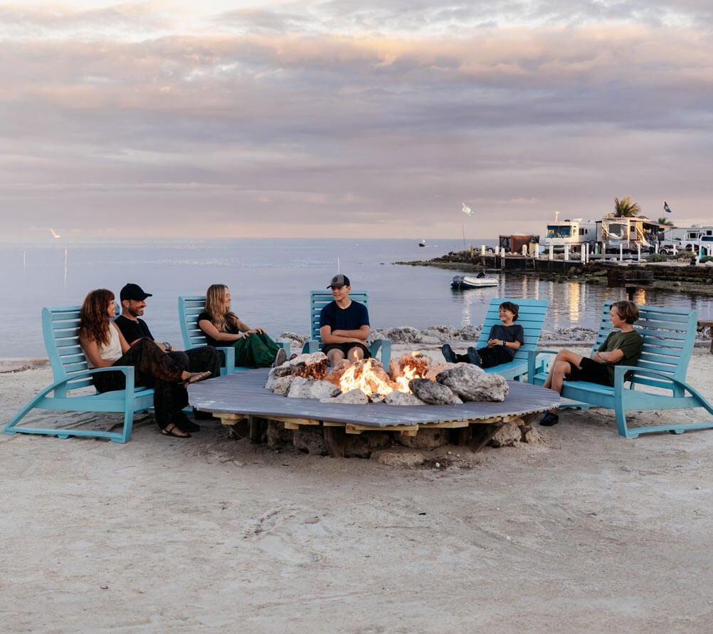 The Hocking family sitting around the oceanside fire pit at Big Pine Key RV Park in Florida.