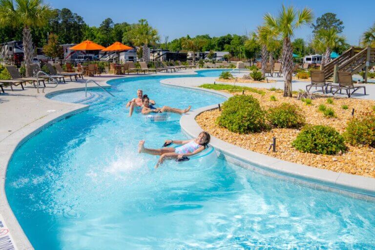 Family floating through a lazy river at CreekFire RV Resort in Savannah, Georgia.