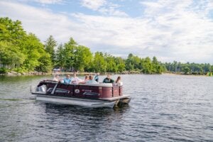 A pontoon boat full of people on Sebago Lake in Maine.
