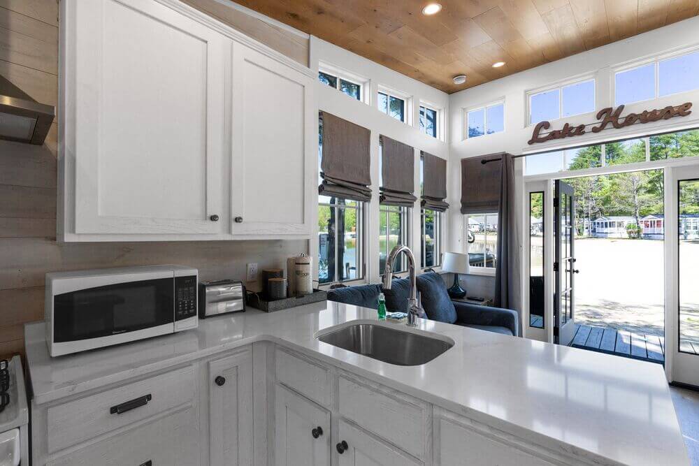 Interior view of the kitchen and living room of the Saltbox Cabin rental at Point Sebago Resort.