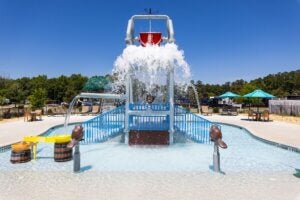 Splash pad bucket dropping water at CreekFire RV Resort in Savannah, Georgia.
