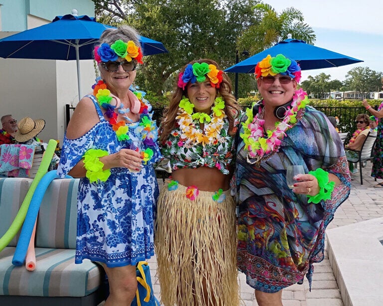 Residents attending a summer luau party at Camelot East Village in Sarasota, Florida
