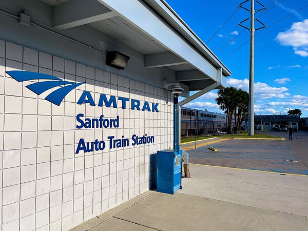 Afternoon sun bathes the Amtrak Auto Train Station as passengers wait to board following a two-hour departure delay.