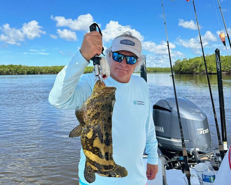 Chokoloskee RV Park Manager Chris Salzo holding a fish