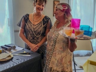 Residents attend a speakeasy murder mystery production in the Marina at Holiday RV Park in Leesburg, Florida.