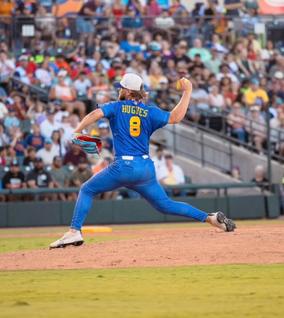 Baseball player pitching at a stadium during a Texas Tailgaters Banana Ball game.