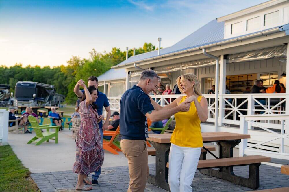 Couples dancing outside the restaurant at CreekFire RV Resort in Savannah, Georgia.