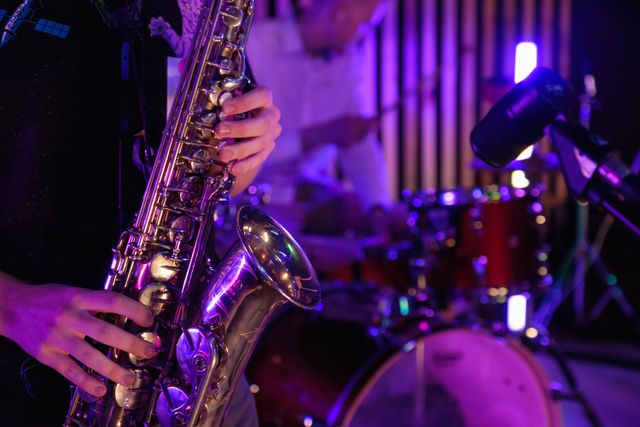 Saxophone player and drummer on stage playing in a jazz band.