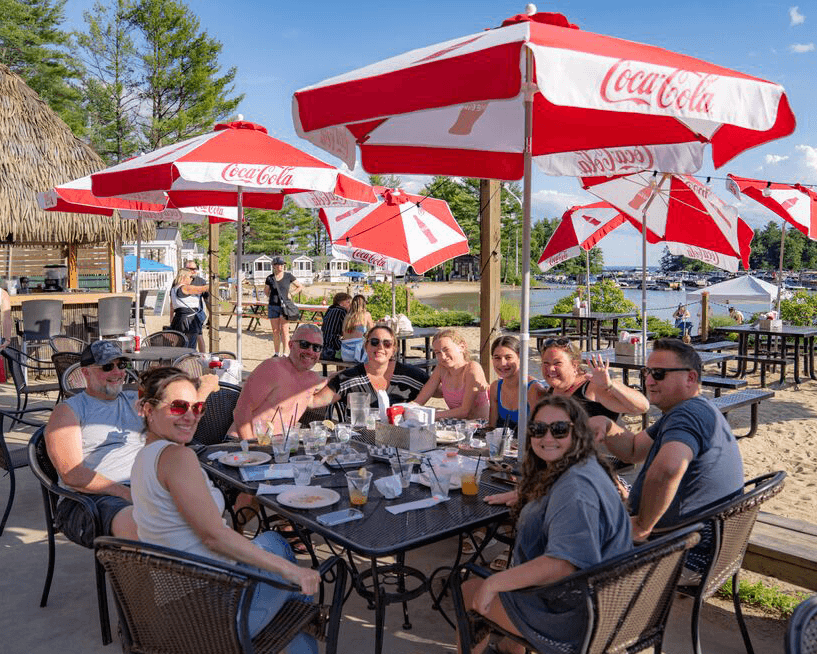 Family sitting at the Tiki Bar at Point Sebago Resort in Casco, Maine
