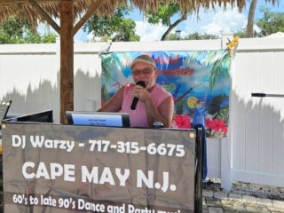 DJ Warzy entertains park guests with live music at the outdoor pool in 55+ Holiday RV Park in Leesburg, FL.