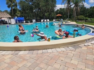 Guests enjoy a summer day in the outdoor pool at Holiday RV Park in Leesburg, Florida.