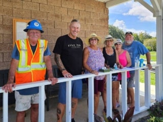 Guests gather by the mini golf course before playing a round at 55+ Holiday RV Park in Leesburg, Florida.