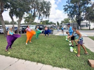 Guests playing outdoor games during Adult Twisted Summer Camp at Holiday RV Park in Leesburg, FL.