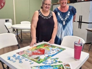 Guests compete in jigsaw puzzle wars during Adult Twisted Summer camp event series at 55+ Holiday RV Park in Leesburg, FL.
