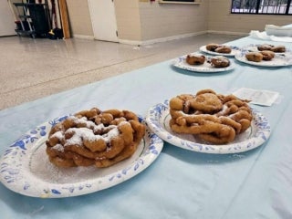 Guest brings funnel cakes for the carnival food competition at Holiday RV Park in Leesburg, Florida.
