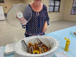 Guest brings corndogs for the carnival food competition at Holiday RV Park in Leesburg, Florida.