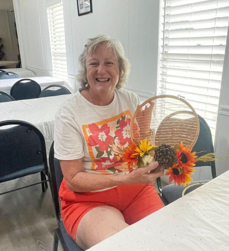 Resident holding a fall craft at the Meadowlea Village in Deland, Florida.