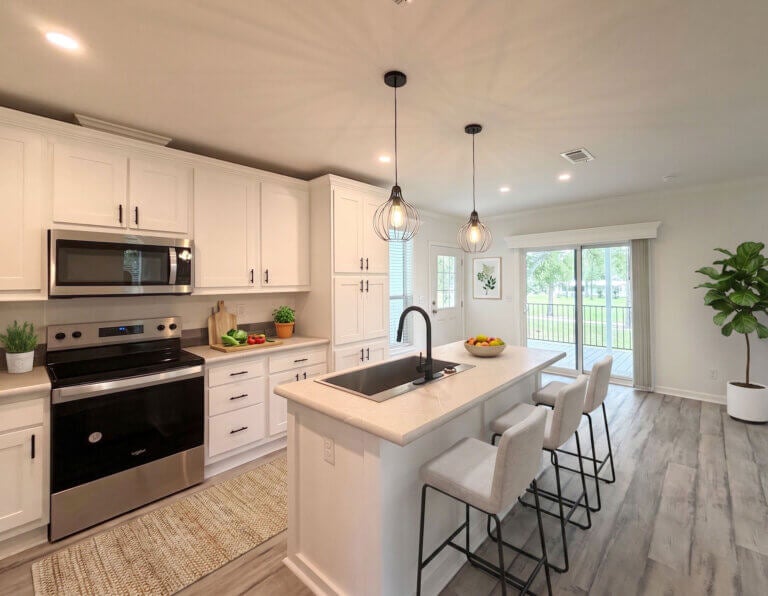 Kitchen area staged with bar stools and decor in Rolling Greens Village.