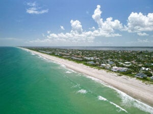 Aerial ocean and beach views on a beautiful sunny Summer day in Melbourne Beach, Florida