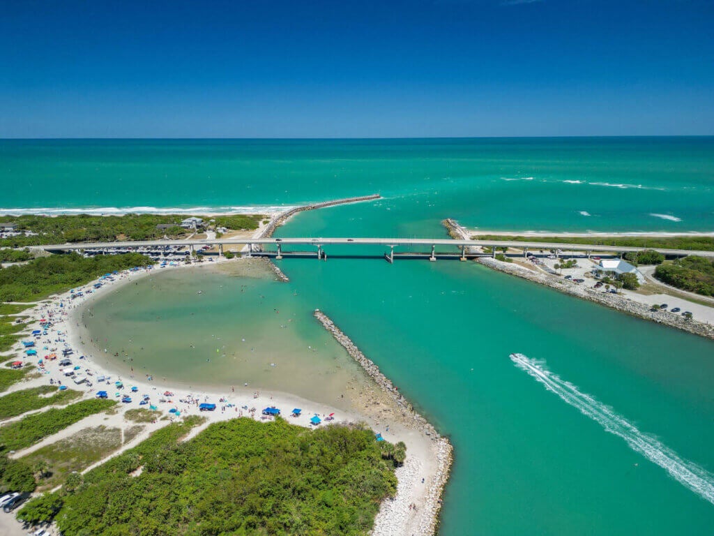 locals and tourists enjoying a sunny summer day in the lagoon at Sebastian Inlet State Park in Brevard County, Florida