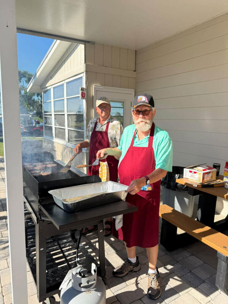 Guest cooking hamburgers on the grill at River Vista RV Park in Ruskin, Florida