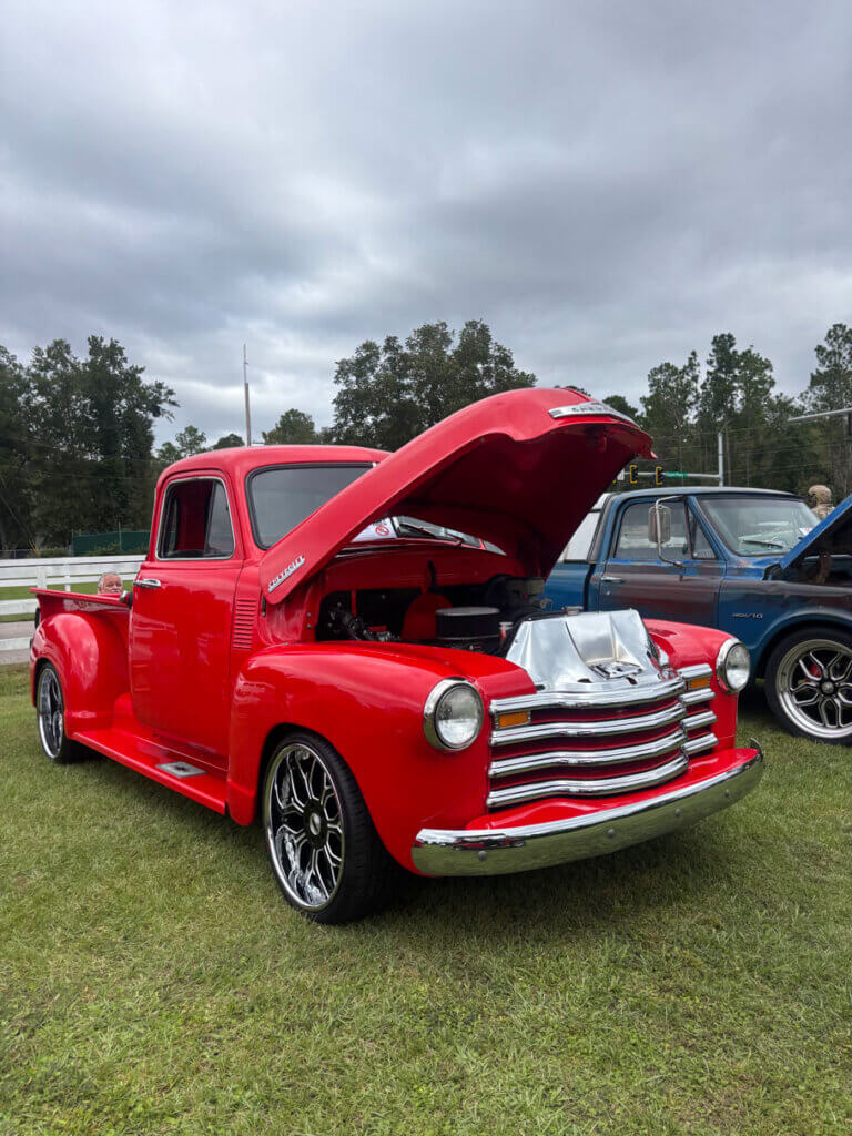red-classic-truck-car-show A classic red pickup truck with the hood up at the October 2026 CreekFire Car Show in Savannah, Georgia.