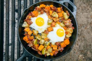Breakfast hash in a skillet over a grill
