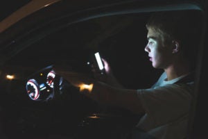 Distracted boy driving at night
